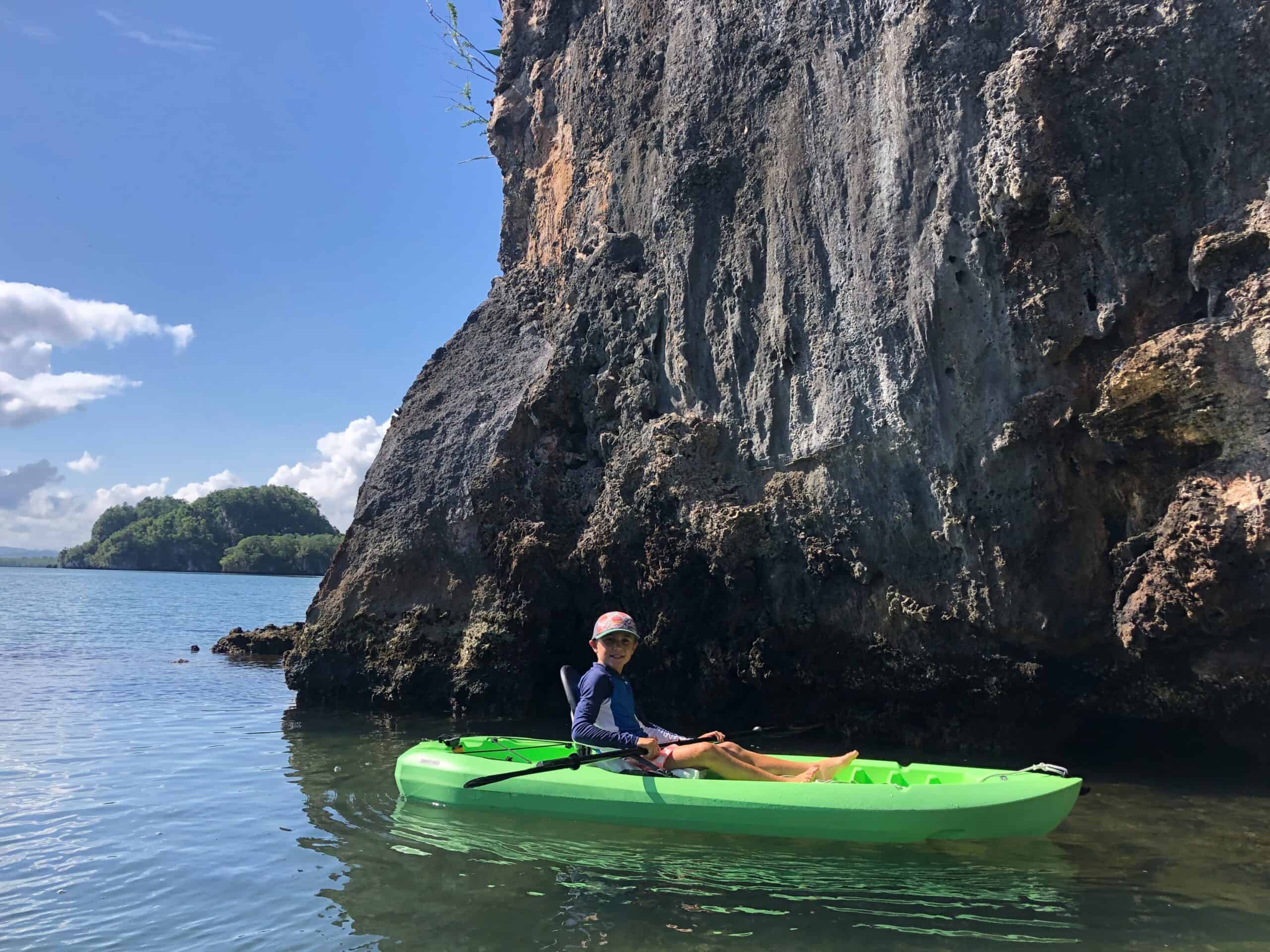 Our son Kayaking in front of a rock face in Los Haitises National Park