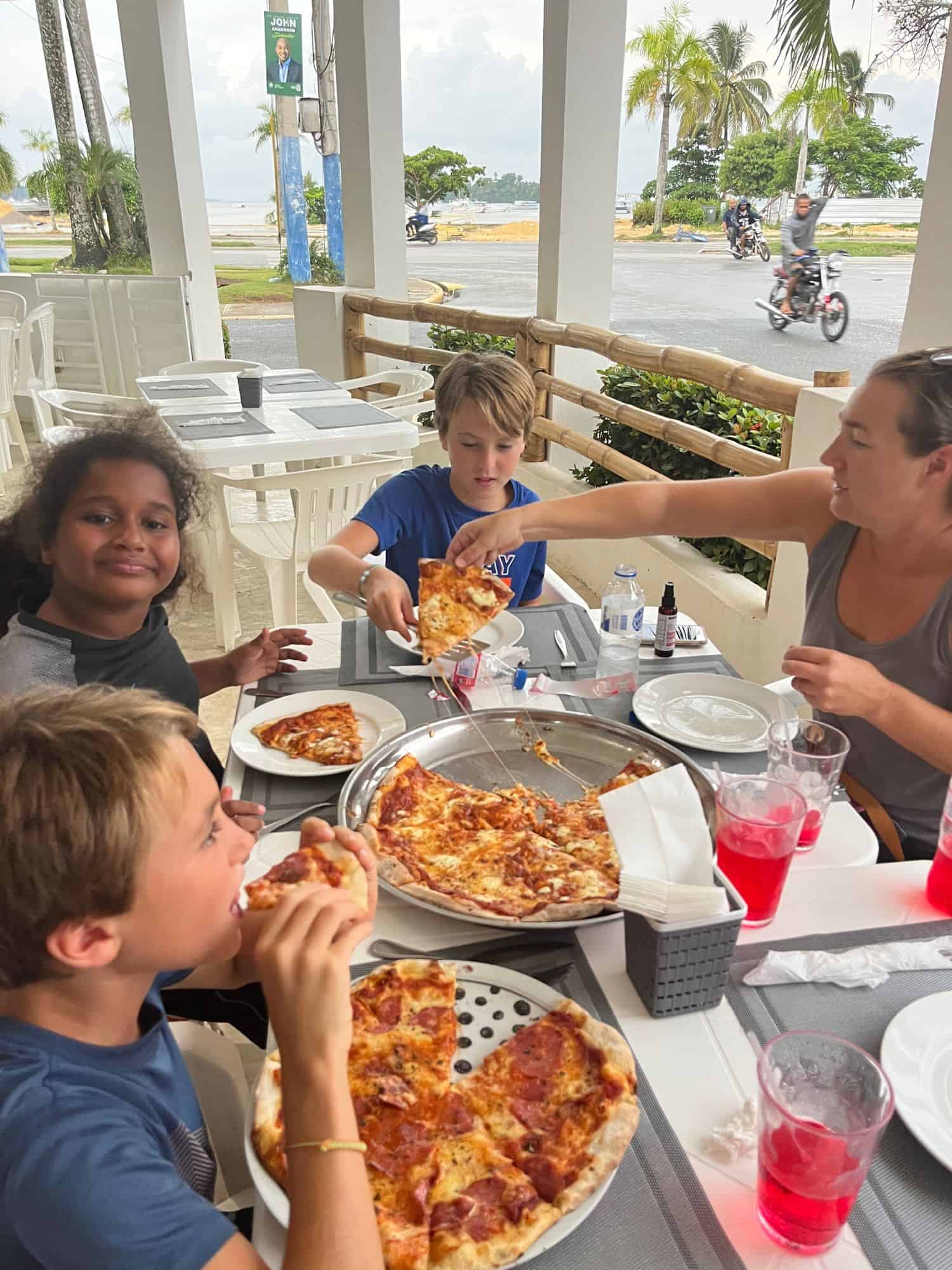 Family eating pizza at Los Hermanos