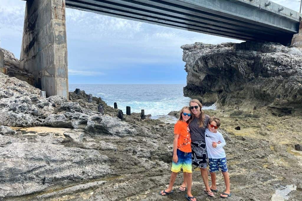 Family standing in front of the glass window bridge