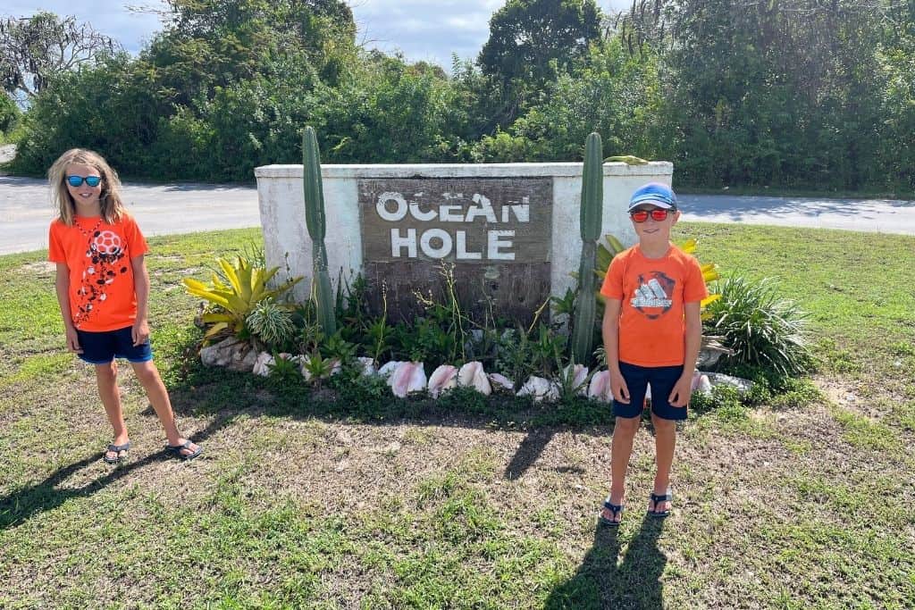 The boys standing in front of Ocean Hole sign